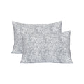 Two gray floral patterned pillows on a white background
